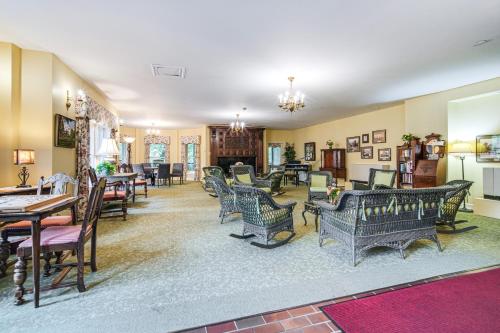 a living room filled with chairs and tables at Experience Chautauqua! Newly Renovated Studio in Chautauqua