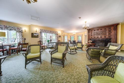 a living room with rocking chairs and a fireplace at Experience Chautauqua! Newly Renovated Studio in Chautauqua