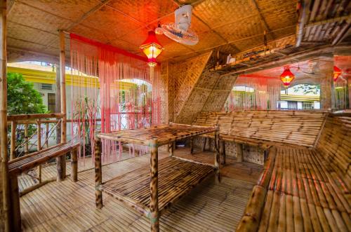 
a wooden bench sitting in a wooden room at Bambooze Hauz in Boracay
