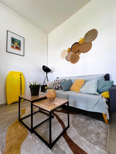 a living room with a couch and a table at Cocon des Alizés in La Moïse