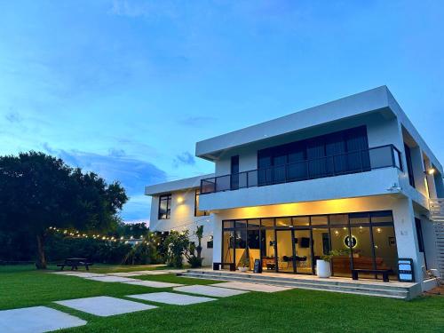 a large house with a lit up facade at night at Still Hills Inn in Hengchun