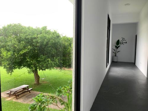 a room with a window looking out at a park at Still Hills Inn in Hengchun