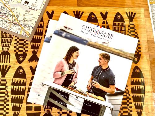 a flyer for a bakery with a man and woman standing at a counter at HAPPY house in Saint-Pierre