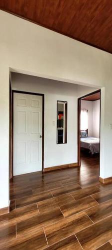 a room with a white door and a bedroom at Villa Marina, Nosara in Nosara