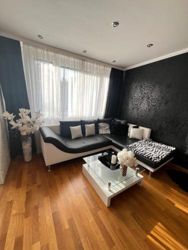 a living room with a couch and a table at Útulný prostorný tichý byt v blízkosti centra in Prague