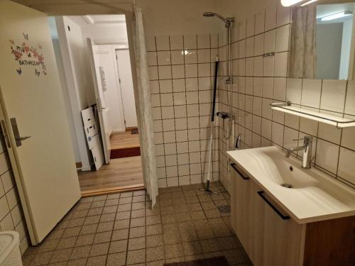 a bathroom with a sink and a shower at Unnuisarfik Iglo Nuuk in Nuuk
