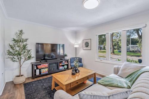 a living room with a couch and a tv at Heritage 3BR Etobicoke Gem, Sherway Gardens, BBQ in Toronto