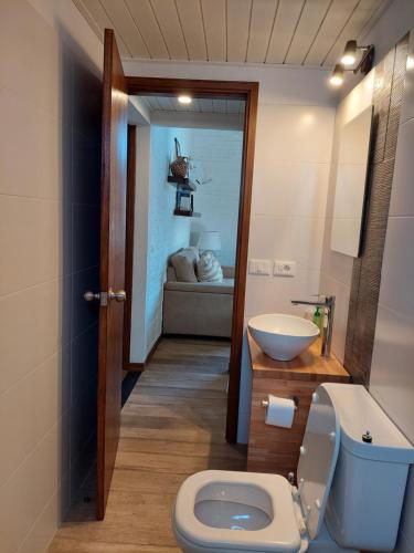 a bathroom with a toilet and a sink at Las Olas in Piriápolis