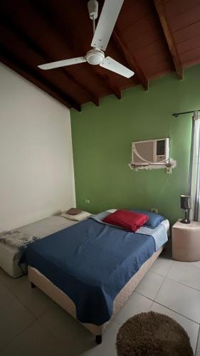 a bedroom with a bed and a ceiling fan at Habitacion privada en casa familiar in San Bernardino