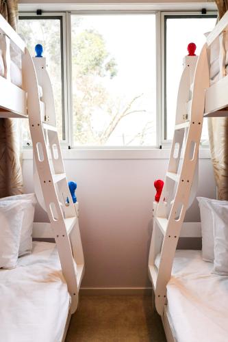 two bunk beds in a room with a window at Bright Modern Holiday Home 7 Beds at Doncaster in Doncaster