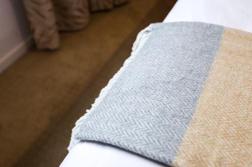 a close up of a blanket on a bed at Bright Modern Holiday Home 7 Beds at Doncaster in Doncaster