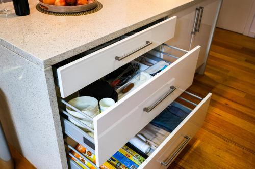 an open drawer in a kitchen with food at Bright Modern Holiday Home 7 Beds at Doncaster in Doncaster