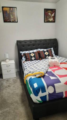 a bedroom with a bed with a black headboard at Carsonway Basement Suite in Edmonton
