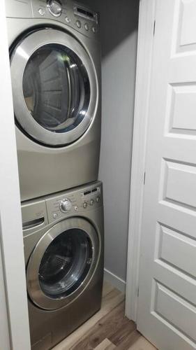 a washer and dryer in a small room at Carsonway Basement Suite in Edmonton