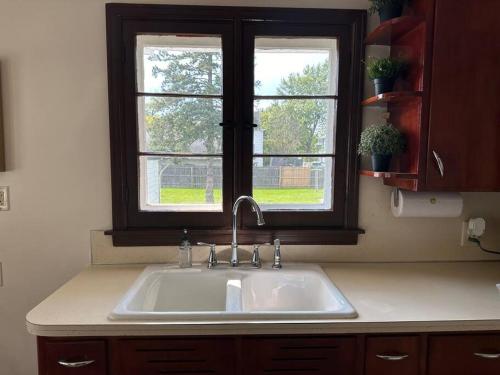 a sink in a kitchen with a window at Wilson Street Home in Little Chute