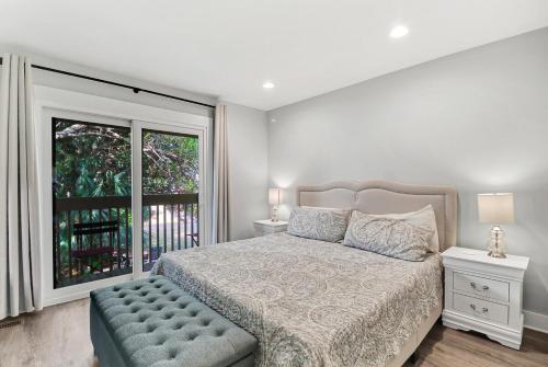a bedroom with a bed and a large window at EZ Beach Access - 2 Bed 2 and one half Bath 23 Coligny Villa in Hilton Head Island