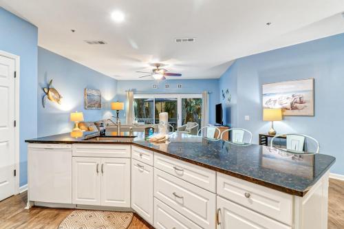 a kitchen with blue walls and a large counter top at Lovely 3 Bed3 Bath Pet FriendlyVilla - Walk to the beach pools and tennis #75 Ocean Breeze in Hilton Head Island