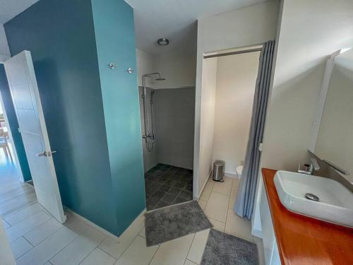 a bathroom with a shower and a sink at Fare Miri Ata Premium - 107m2 Panoramic view in Punaauia