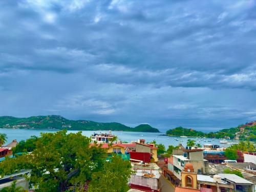 a view of a city and a river with buildings at Hotel Zihuatanejo Centro in Zihuatanejo