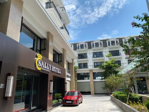 a red car parked in front of a building at Sally Hotel in Yen