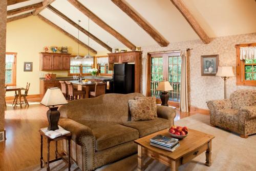 a living room with a couch and a table at Chanticleer Cabins in Sturgeon Bay