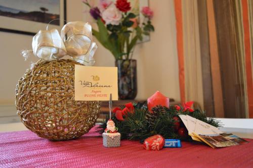 a pineapple on a table with flowers and candles at Villa Adriana B&B in Comiso