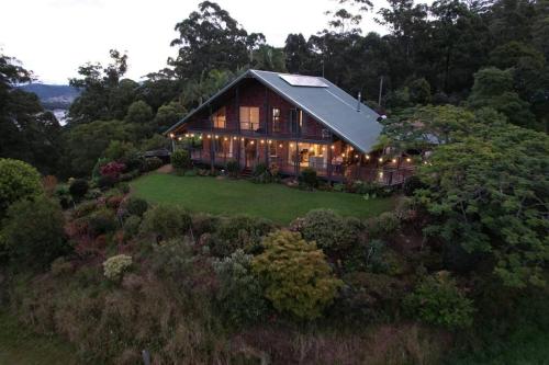 an overhead view of a house on a hill with lights at Cloud Valley Estate -Chalet in Bowraville