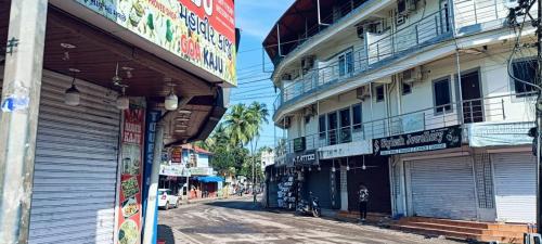 a city street with two tall buildings on the side of it at Hotel Baga inn in Baga