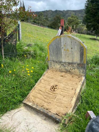 a wooden bench sitting in the grass in a field at Chalet Villa Ines un paraiso en las montañas in Duitama