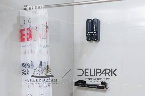 a bathroom with a hair dryer on a wall at Delipark Mall 3 Bedrooms 3 Bathrooms 8-10 Pax Empire Premium Tower Level 28 in Medan