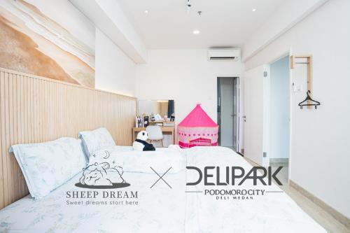 a bedroom with a bed with a sign on it at Delipark Mall 3 Bedrooms 3 Bathrooms 8-10 Pax Empire Premium Tower Level 28 in Medan