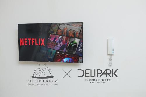 a book with a picture of a group of movies at Delipark Mall 3 Bedrooms 3 Bathrooms 8-10 Pax Empire Premium Tower Level 28 in Medan