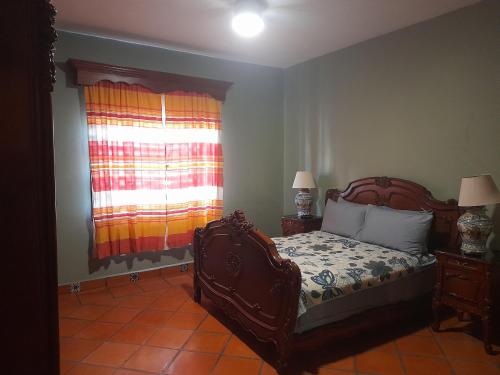 a bedroom with a bed and a window at Casa tipo colonial en Colima in Colima