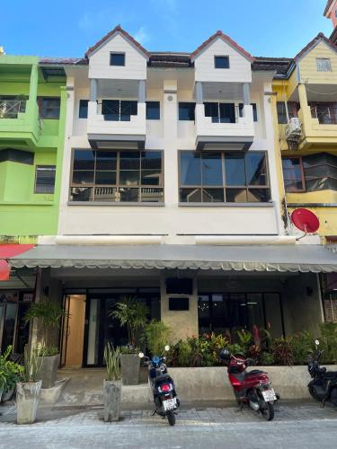 two motorcycles parked in front of a building at BH Cozy Paradise Patong in Patong Beach