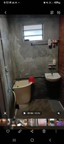 a bathroom with a tub and a sink at RUMAH KAYU ED BEACH Cafe in Kuala Kedah