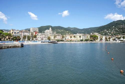 a large body of water with buildings in the background at Appartamento del Golf - Secured Parking - in Rapallo