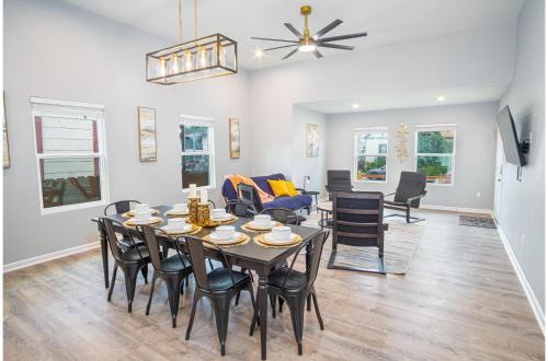a dining room and living room with a table and chairs at Seize the Moment 4BR3BA Gem w Downtown Views in San Antonio