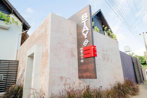 a building with a red box on the side of it at Stay at 3 in Negombo
