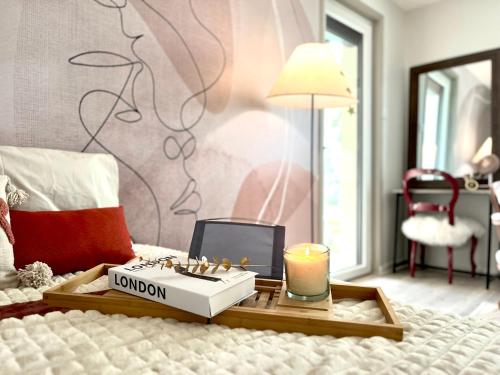 a tray with a candle and a box on a bed at Villa des cèdres in Saint-Bonnet-les-Oules