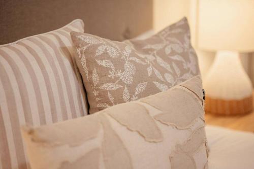 a white couch with two pillows and a lamp at Stay Seaside Market 416 in Woolgoolga
