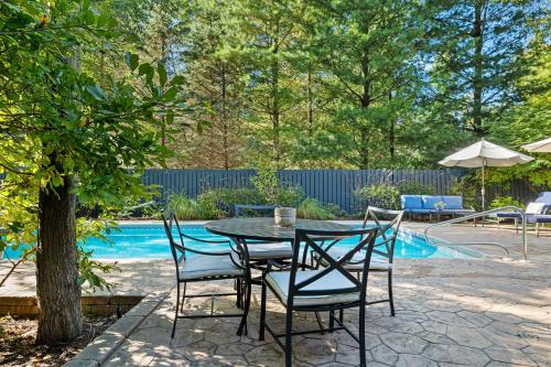a table and chairs next to a pool at Bella and Dulce's Lakehouse in Union Pier
