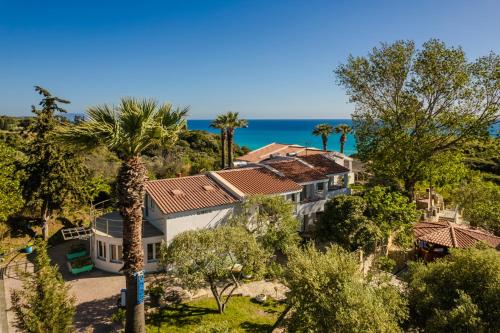 an aerial view of a house with the ocean in the background at Costa Avithos in Svoronata