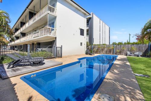 a swimming pool in front of a building at Ocean Spray 8 in Coffs Harbour