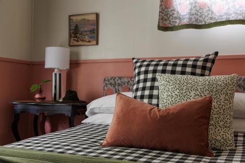 a bedroom with a bed with pillows on it at Poppy's Place - Denmark in Denmark