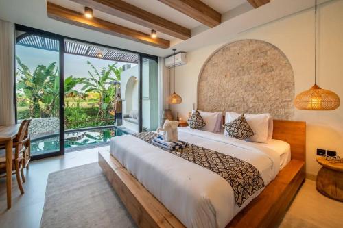a bedroom with a large bed and a large window at Casa Tua - Hidden Ubud Gem Views in Ubud