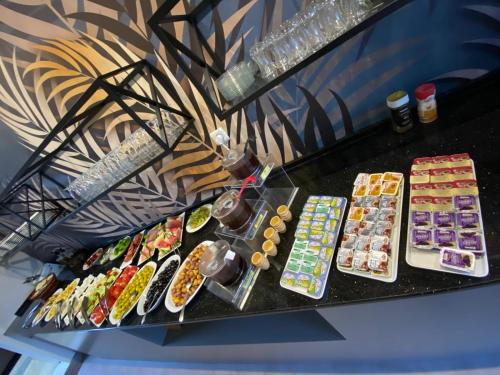 a bunch of different types of food on a table at My Rezidans Hotel in Manisa