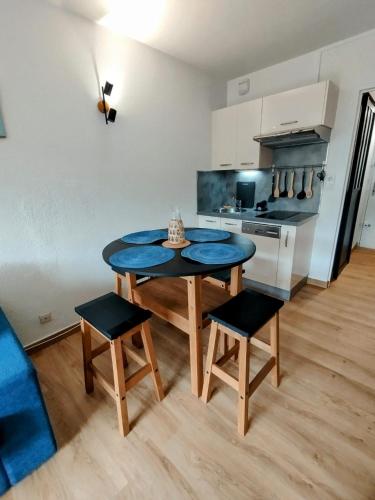 a kitchen with a table and chairs in a room at Charmant studio cabine in Cap d'Agde