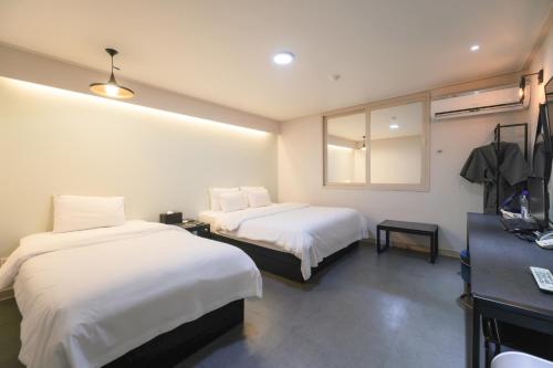 Postel nebo postele na pokoji v ubytování VIP Hotel Mokpo