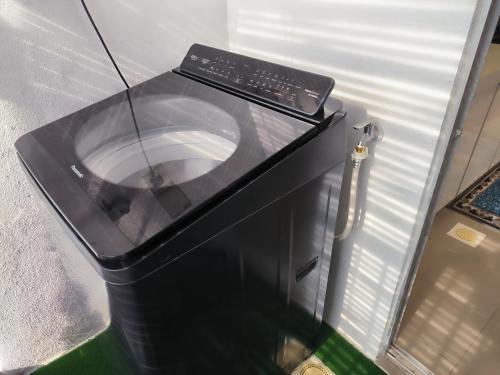 a microwave oven sitting on top of a trash can at Homestay Naufal Bandar Sri Sendayan Ground Floor in Seremban