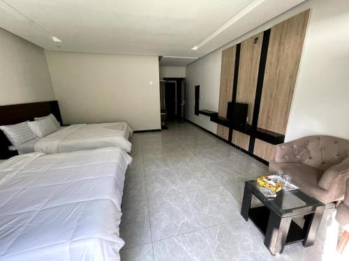 a hotel room with a bed and a couch and a table at Keran Retreat in Upper Neelun